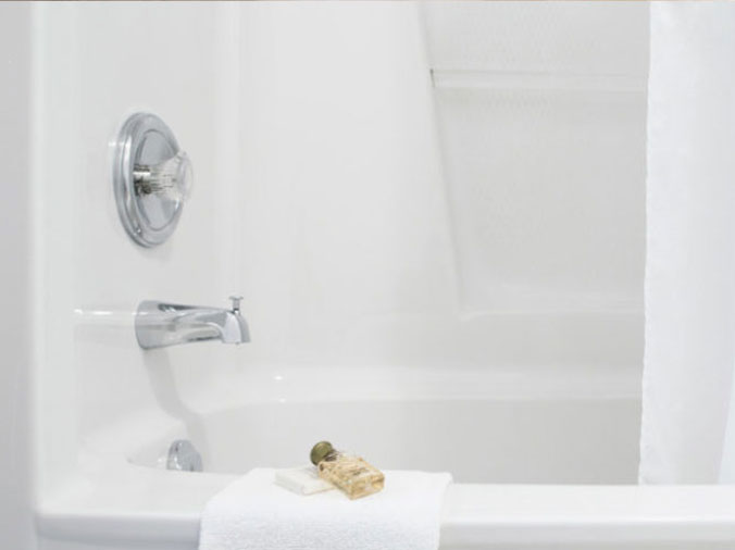 Bathtub with polished chrome faucet