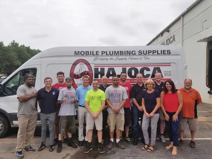 Hajoca Plumbing Raleigh service team posing in fromt of a delivery truck